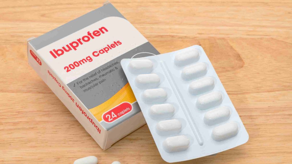 Pack of ibuprofen 200mg caplets on a wooden surface, representing safer alternatives and recommendations for pain management.