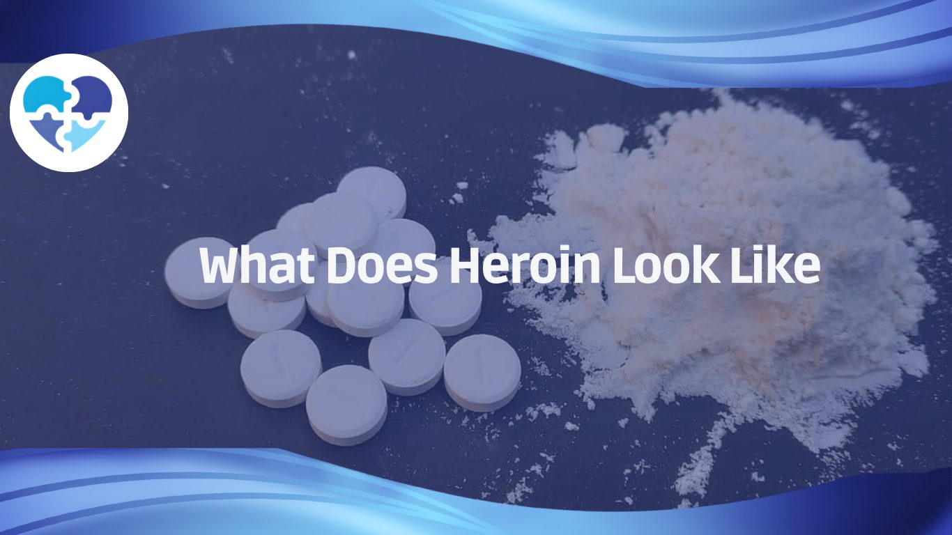 White tablets and a pile of white powder on dark surface, showing common physical forms of heroin.