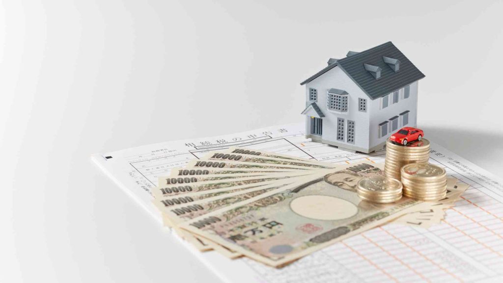 Model house, yen currency notes, and documents symbolizing financial requirements for inpatient addiction treatment coverage.