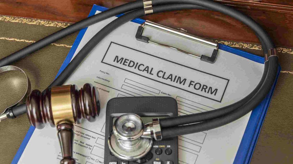 Medical claim form with stethoscope and gavel, symbolizing common challenges like claim denial and how to overcome them.