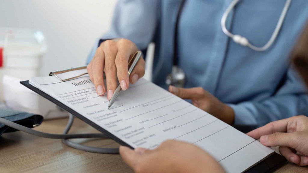 A medical assessment form in patient's hand, showing how to access Cigna EAP benefits for opioid rehab through evaluation.