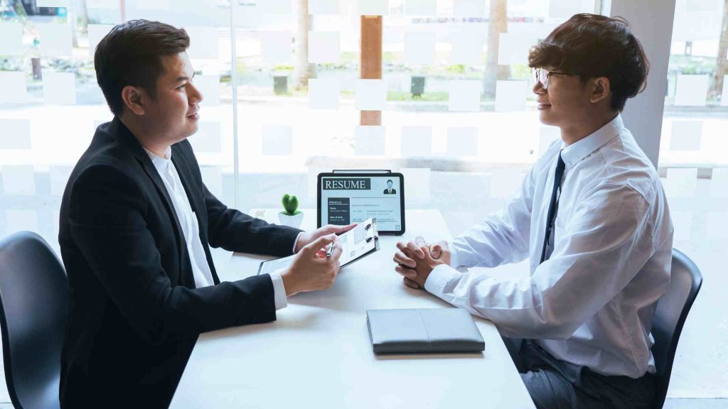 Employer and employee reviewing documents, highlighting the need for proper paperwork when preparing for opioid rehab.
