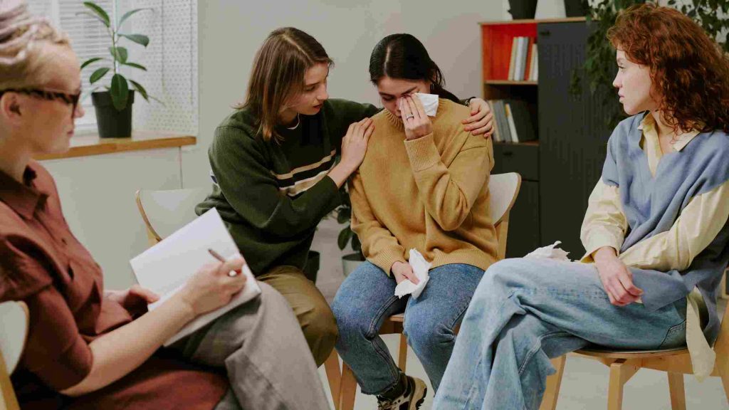 Therapist leading a counseling session and giving support, symbolizing Aetna PPO coverage for outpatient addiction treatment.