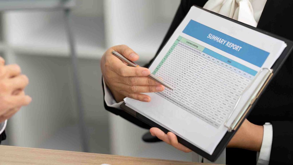 Person reviewing summary report on a clipboard, symbolizing verification of Blue Cross rehab benefits for Arizona residents.