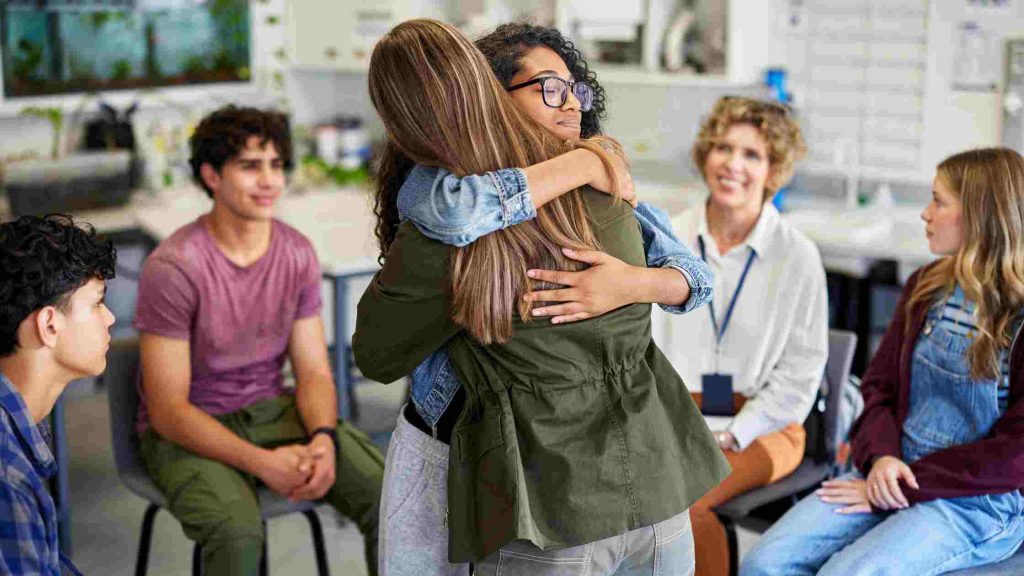 A group therapy session offers emotional support, showing Aetna’s coverage for outpatient counseling and mental health rehab.